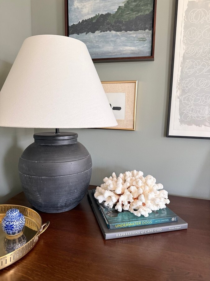 Styled lamp vignette with art and coral